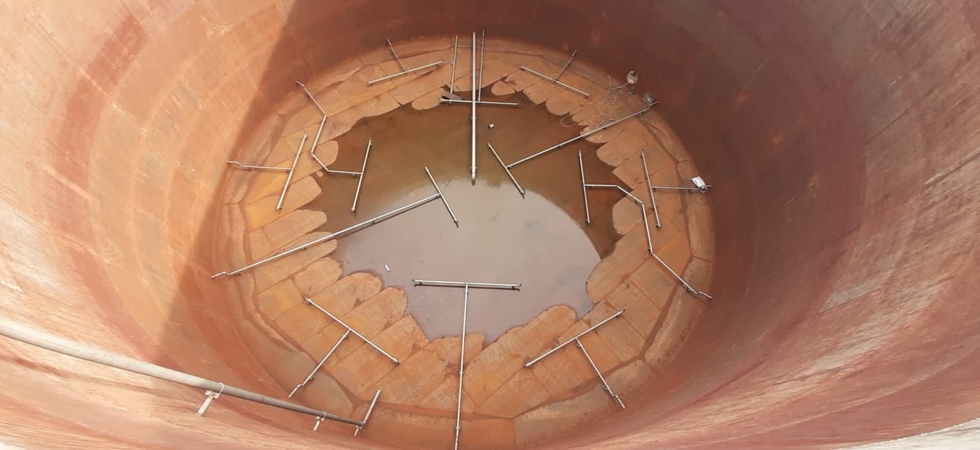 Overhead view of gas injection lines distributed across a digester floor